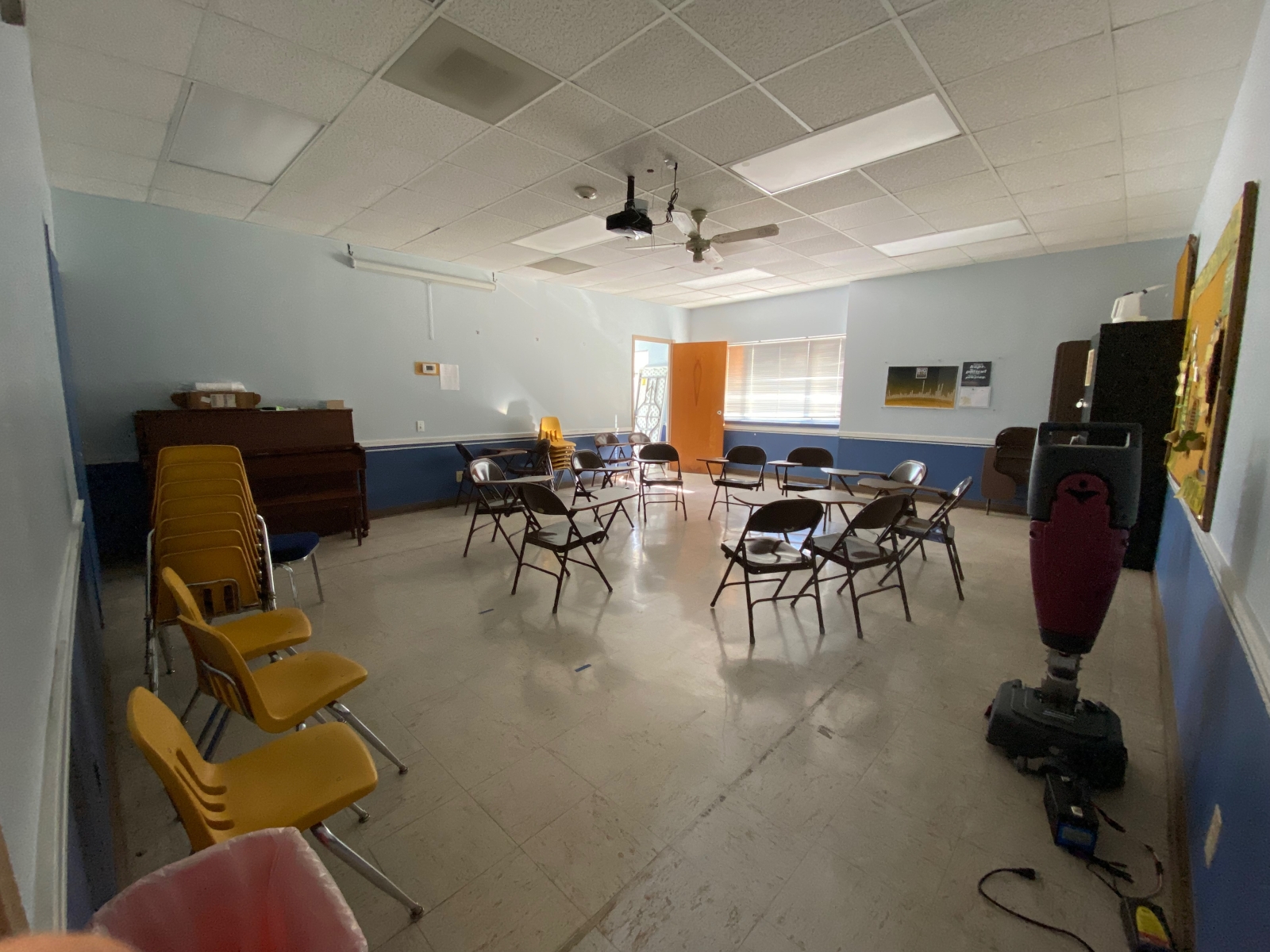 Room 201 has a piano, some student desks, and a projector/screen.