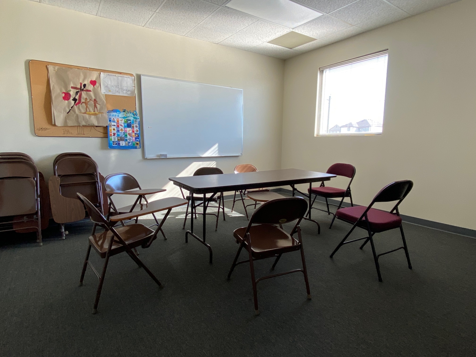 Room 218A has a whiteboard, a table, and some student desks.